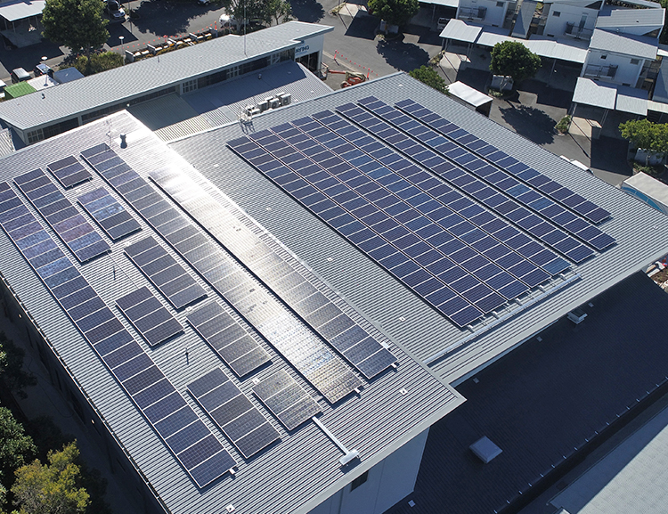 Aerial view of solar panels across industrial rooftops